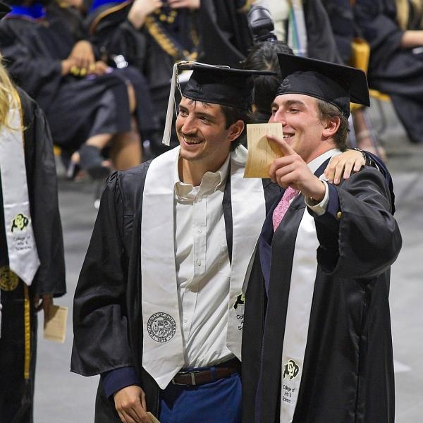 These BFFs get their photo taken by mom/dad before crossing the stage