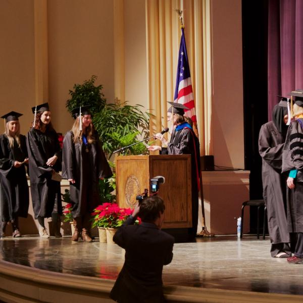 students crossing stage