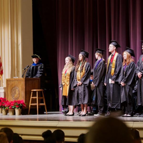 Professor Dick Olson presents the students graduating with Latin Honors