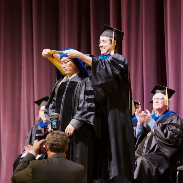 Cognitive student Wani Woo is hooded by his PhD advisor Professor Tor Wager