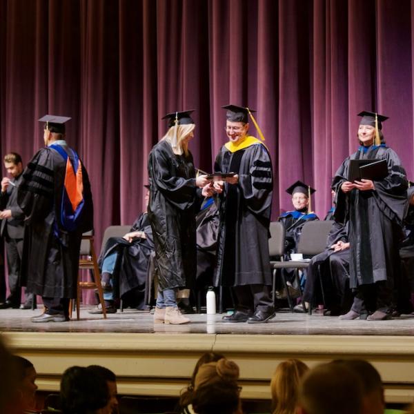 Another student crosses the stage