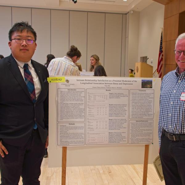 Yuze Shi with his poster and advisor Mark Whisman