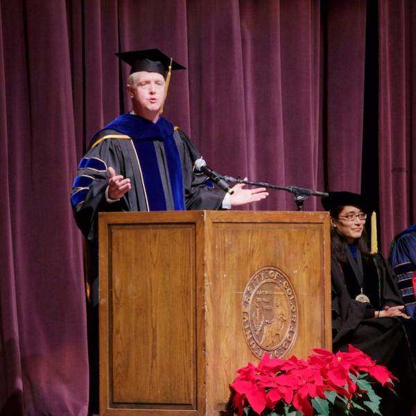Professor Brett King addresses the graduates with a moving speech