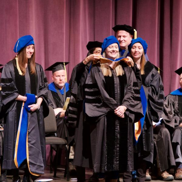 Jane Barker is hooded by her mentor Professor Yuko Munakata