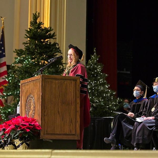 Instructor Jenn Stratford addresses the graduates