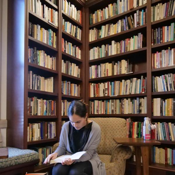 student studying in library, ostensibly in grad school