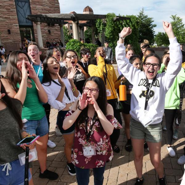 Group of students cheering outside