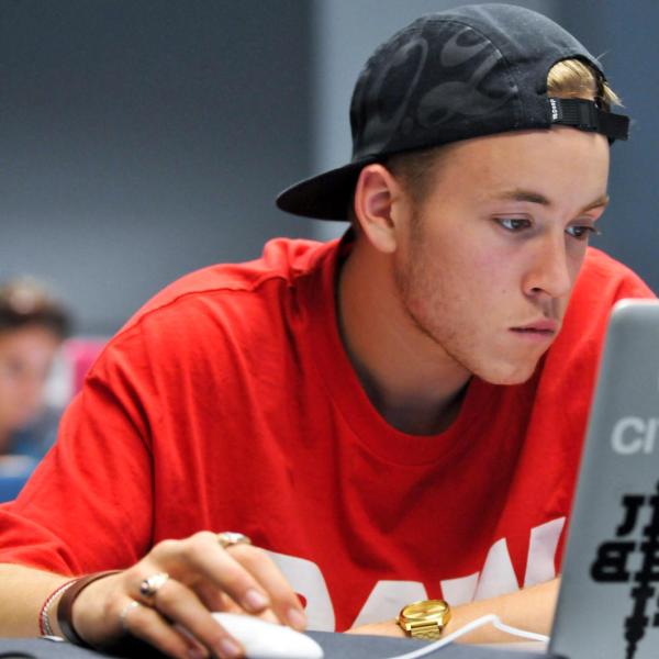 student registering for classes on his laptop