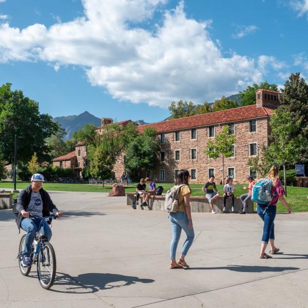 Students walking and studying on campus between class during fall semester.