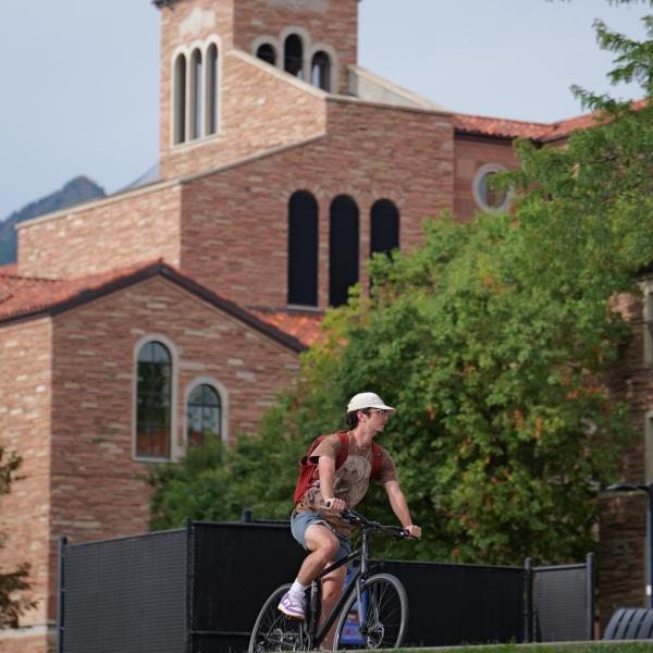 Student biking on the University of Colorado Boulder campus