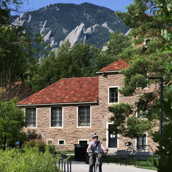 Student biking on the University of Colorado Boulder campus