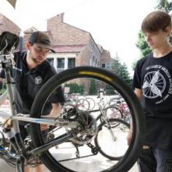 Bike mechanic fixes a student's bike.