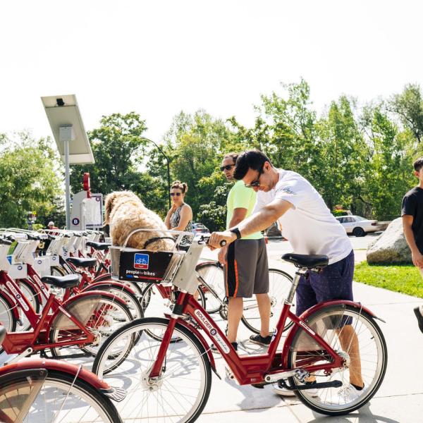 Riders undock bicycles from a BCycle station.