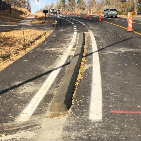 Concrete curb separates bike lane from car lane.