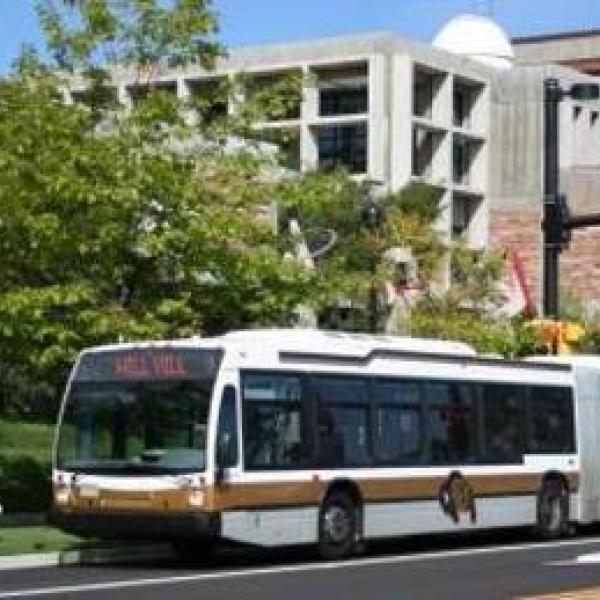 Buff Bus driving down a road on CU Boulder campus