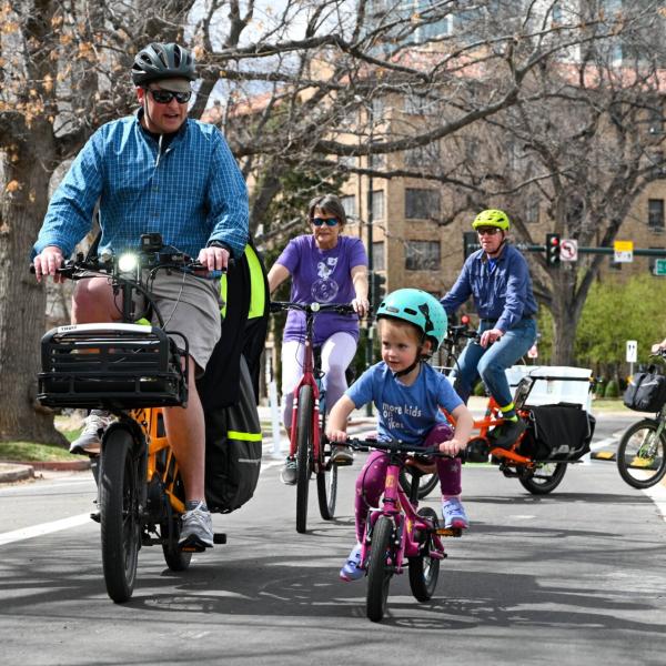 Family biking down a Colorado residential street