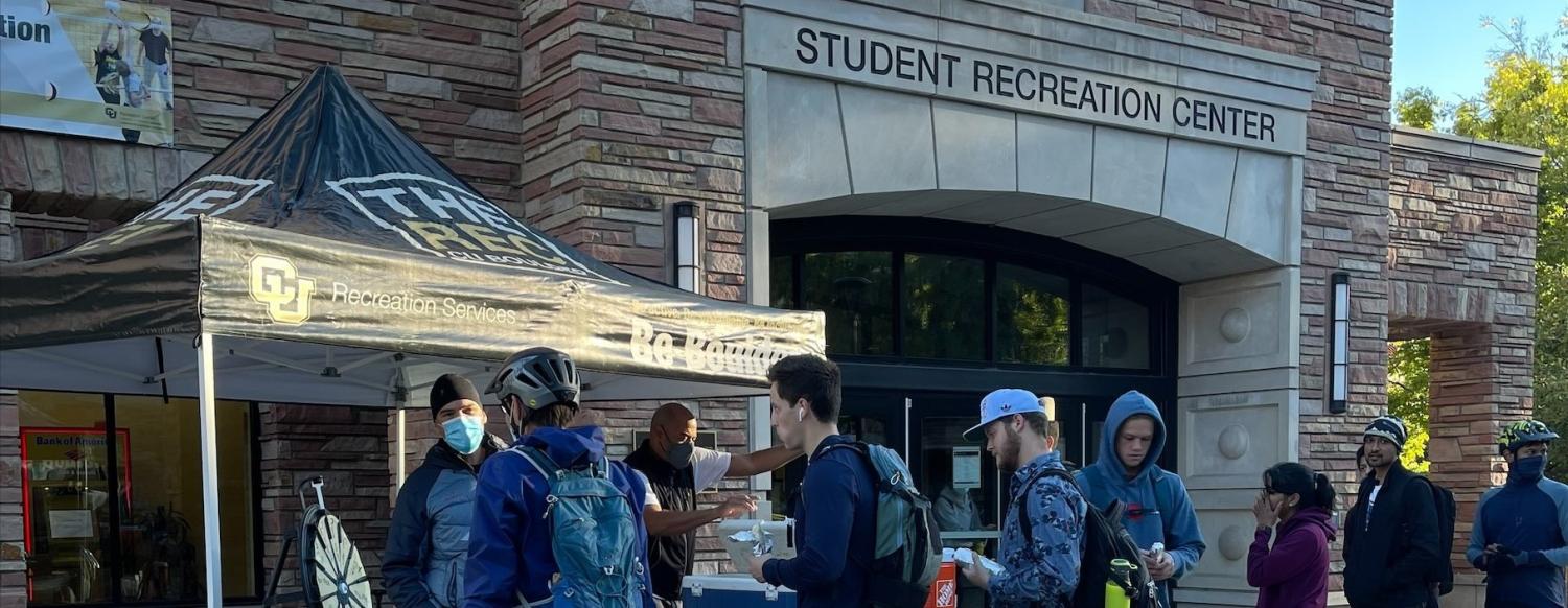 Riders line up at the breakfast station near the CU Rec Center on Bike to Work Day.