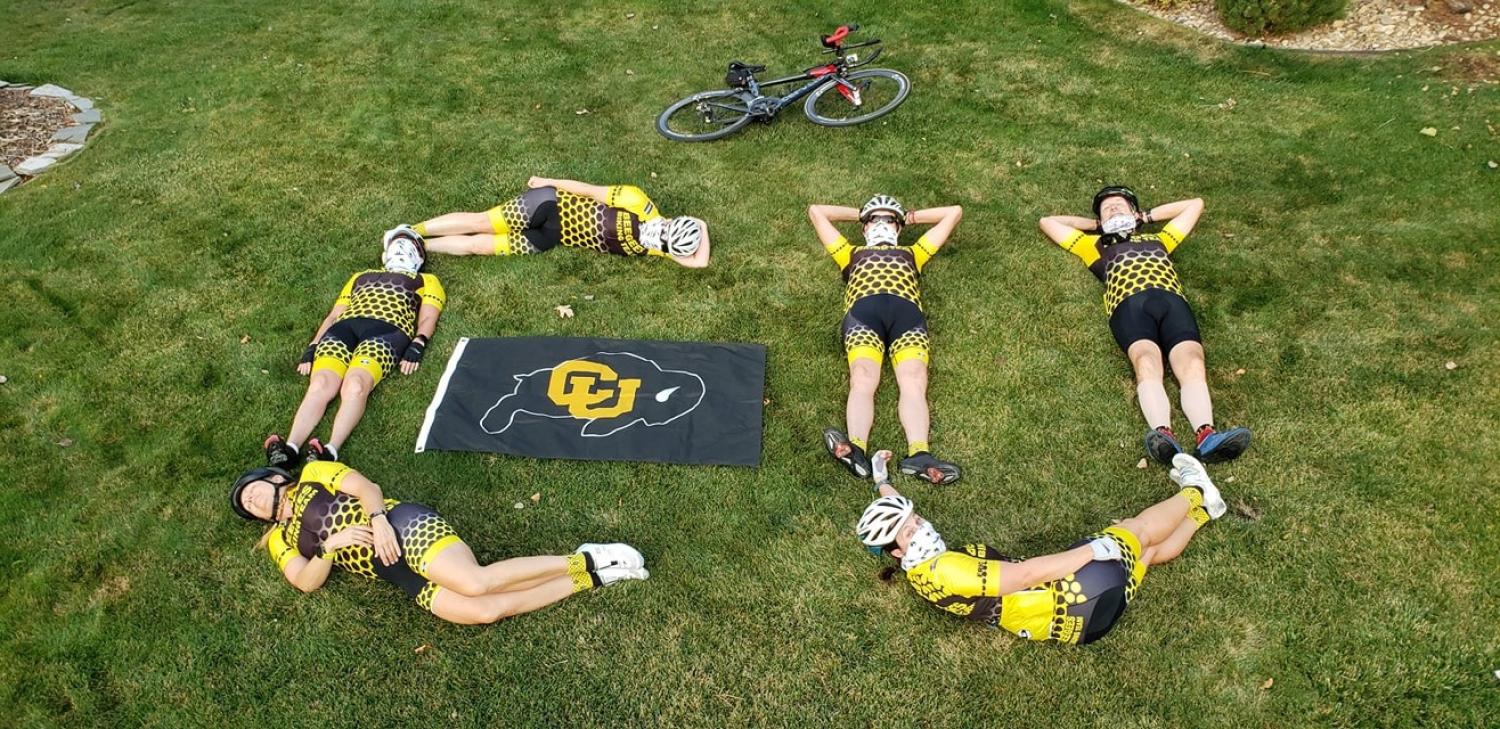 Bicyclists form the CU logo.