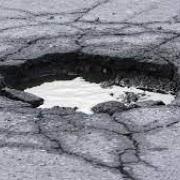 Large pothole on road.