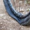 A flat tire on a dirt trail.