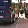 Citizens boarding the Flatiron Flyer at a bus stop.