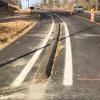 Concrete curb separates bike lane from car lane.