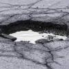 Large pothole on road.