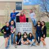 students stand around centaurus high school sign