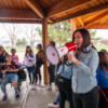 Charla holding megaphone with group of students