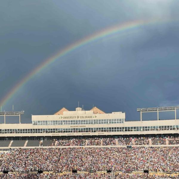 Stadium concert with rainbow in background