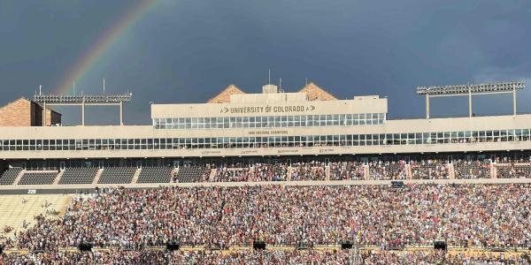 Stadium concert with rainbow in background