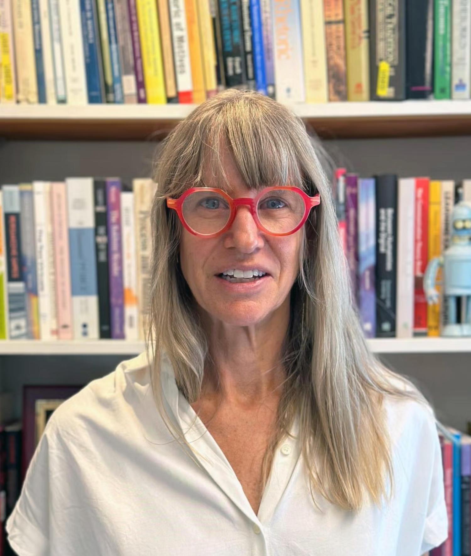 Laurie Gries standing in front of bookshelves