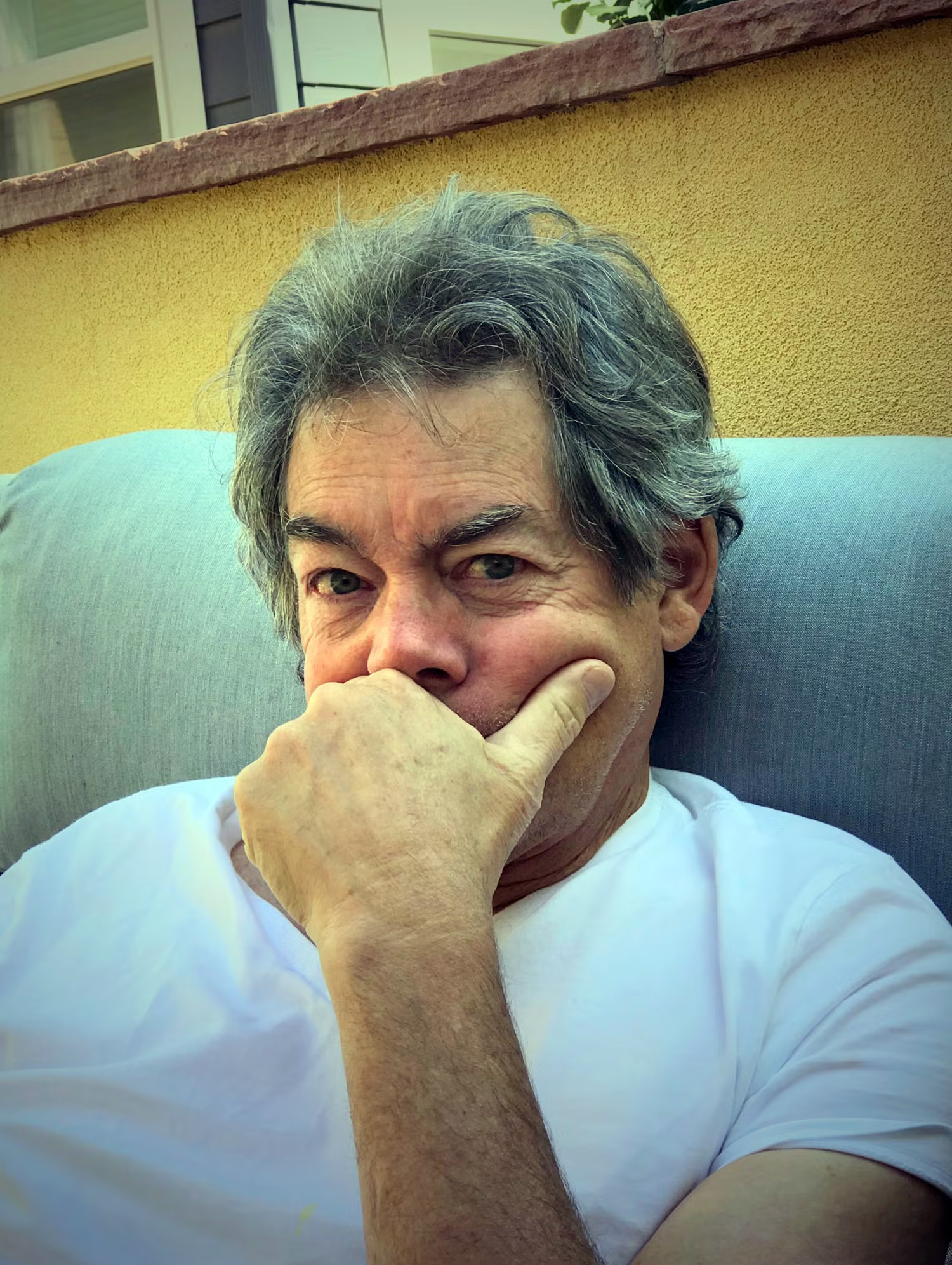 John Ackerman in a chair, thinking