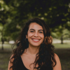 Marisa Tirado smiling in front of a wooded area