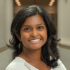 Wide shot of Nisha Shanmugaraj in a hallway