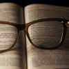 A book with glasses on the pages