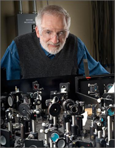 Art Nozik working above a laser bench