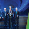 Men standing at a podium