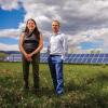 Kyri Baker and Bri Mathias Hodge standing in front of solar panels