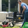 man pushing a lawn mower