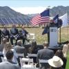 Secretary of Energy Jennifer Granholm stands on a stage outside NREL for a press conference