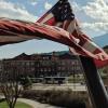 American flag in the wind above CU Boulder campus