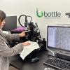 A researcher examining a piece of material under a microscope