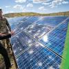 Kate Anderson inspecting outdoor solar panels