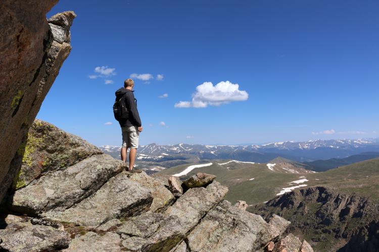 man alone looking out over the mountains