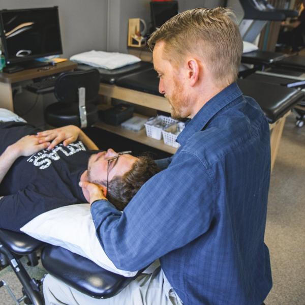 Physical therapist working with student.
