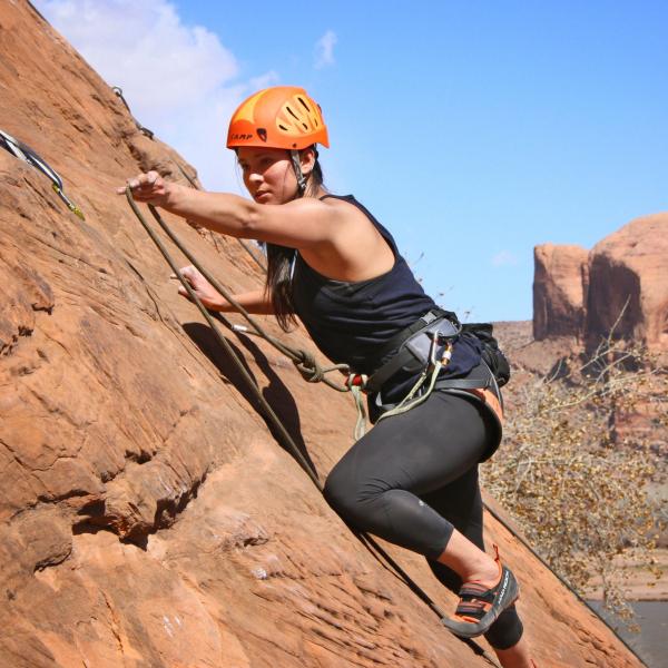 Student climbing rock formation