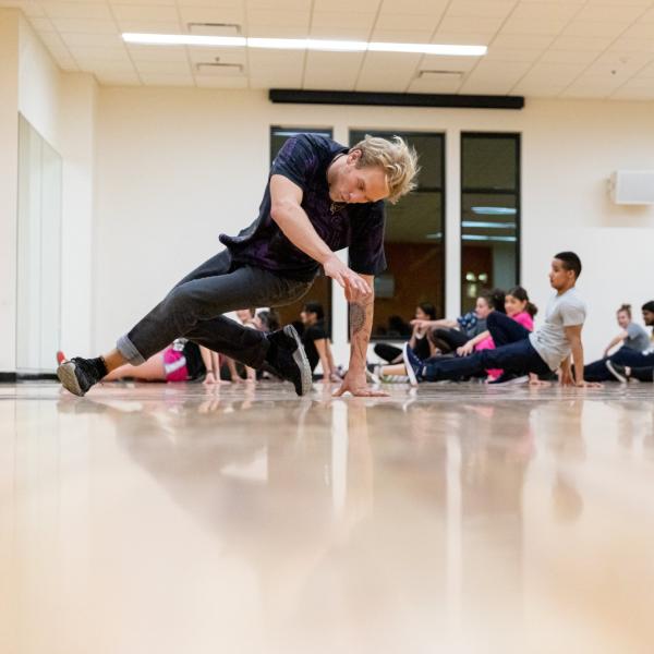 man breakdancing in a class