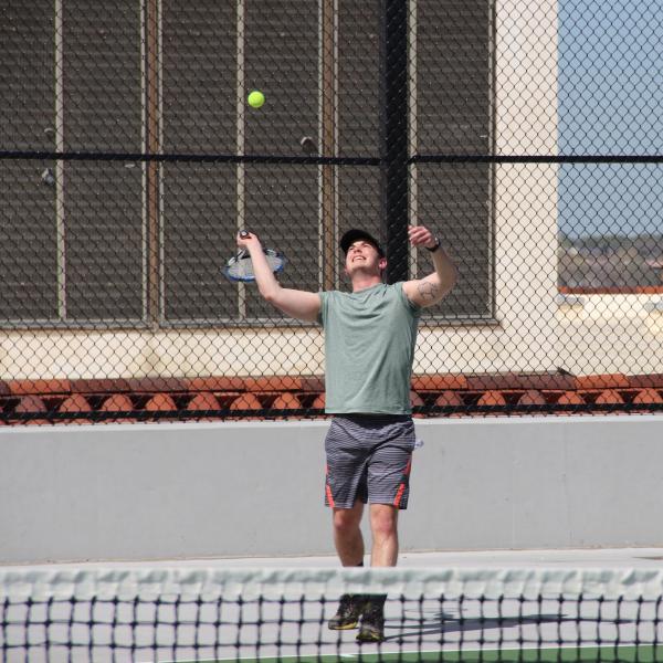 student playing tennis