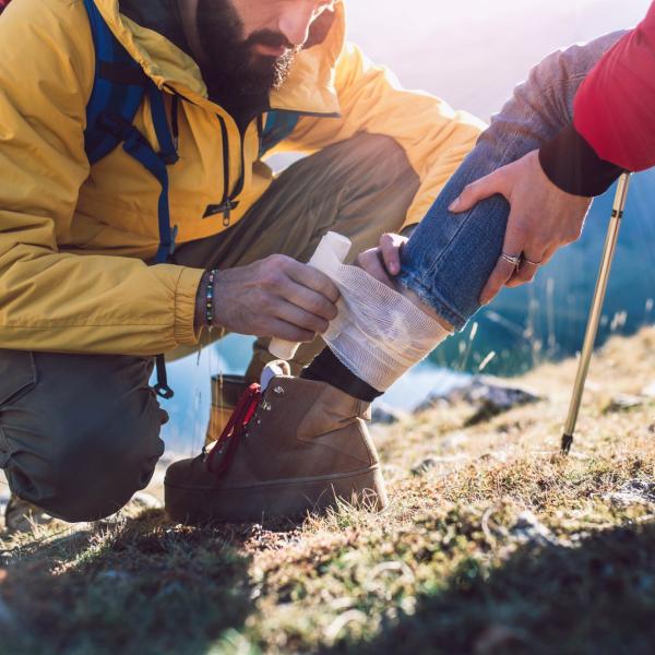 a bandage being applied in the wilderness